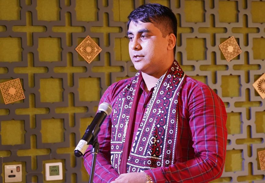 Abbas Korejo speaking at a podium